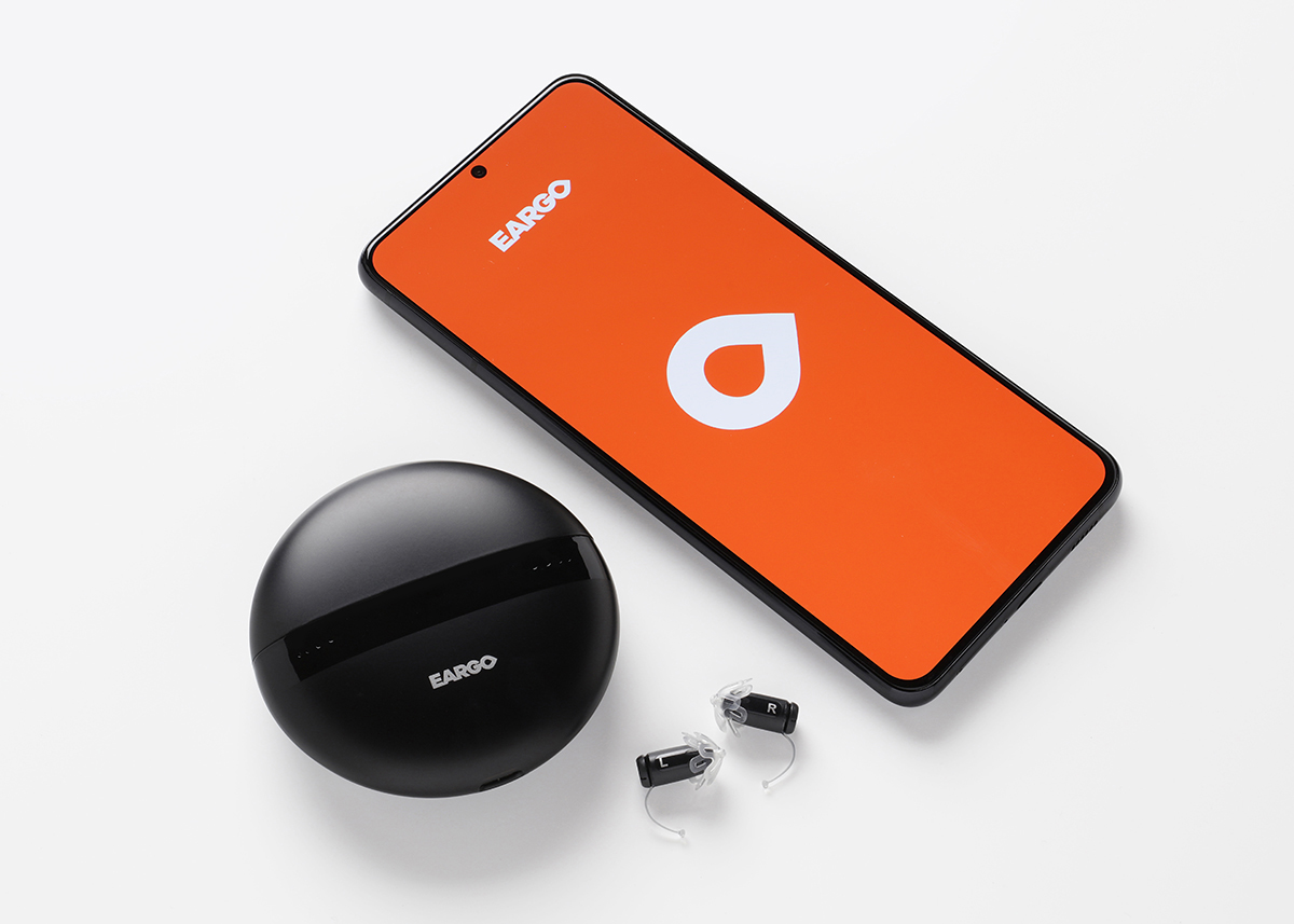 Eargo 5 mobile app interface displayed on smartphone with charging case and hearing aid devices
