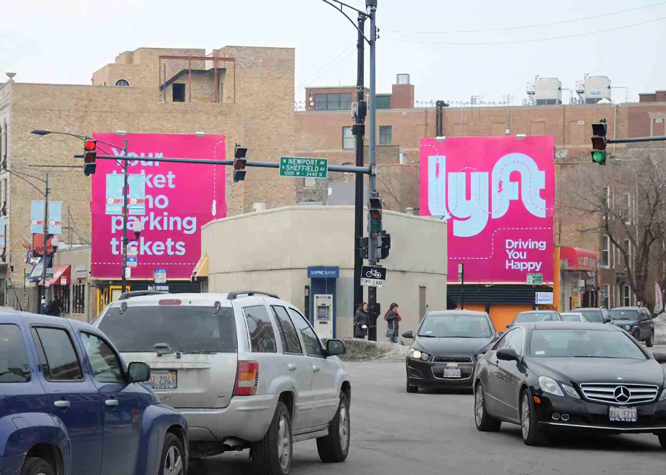 Lyft double billboard advertisement in Chicago featuring Driving You Happy campaign with illustration system