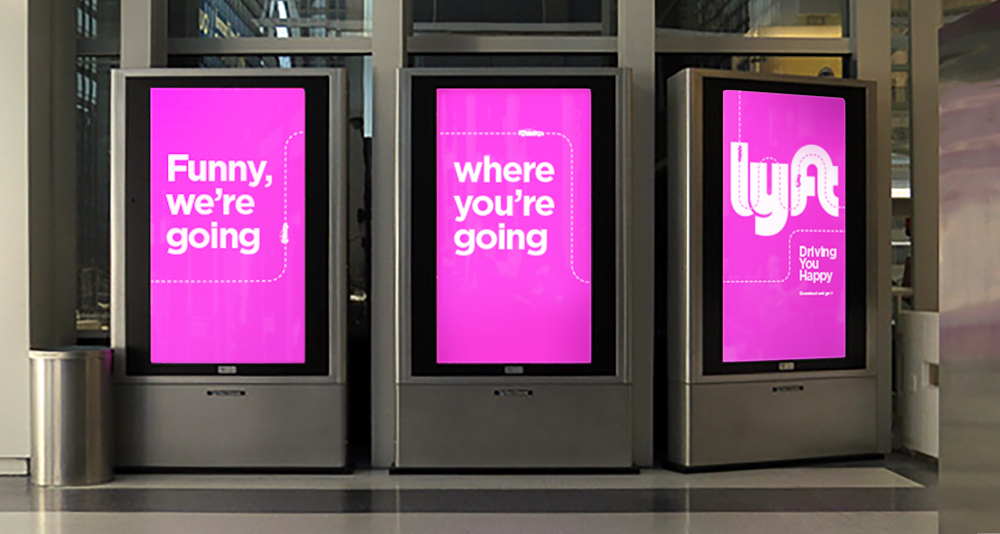 Lyft digital advertisement displayed on Metra train station screen in Chicago featuring Driving You Happy campaign