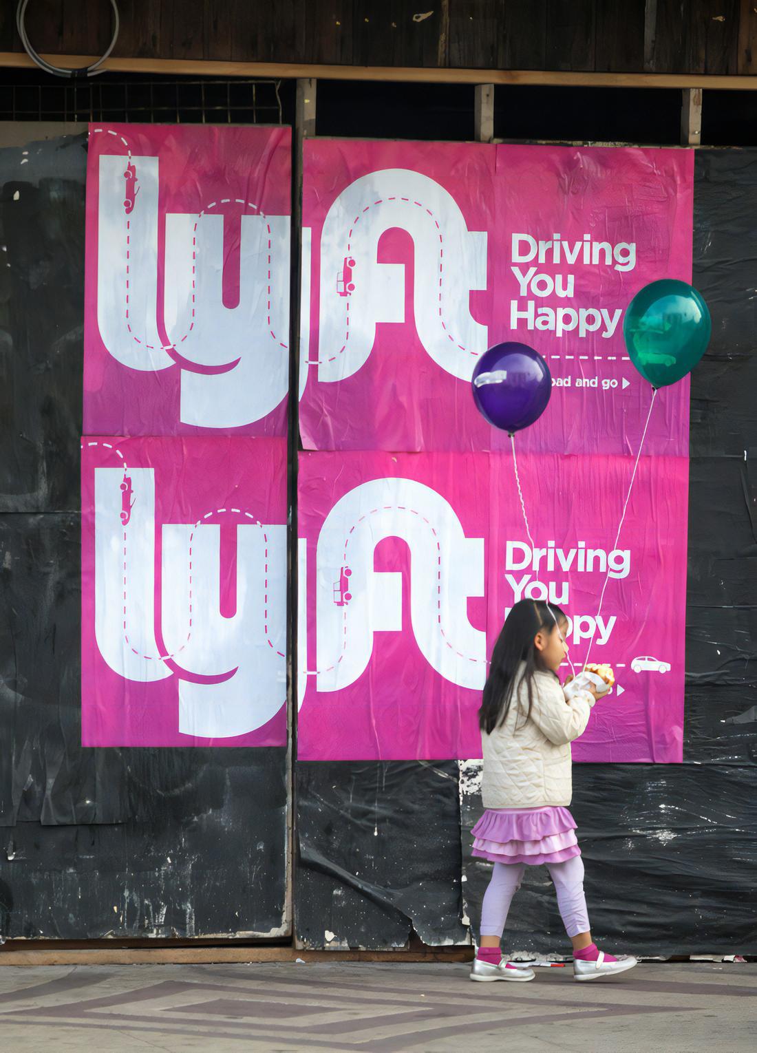 Lyft guerilla marketing wild posting advertisements featuring Driving You Happy campaign with brand messaging and illustrations